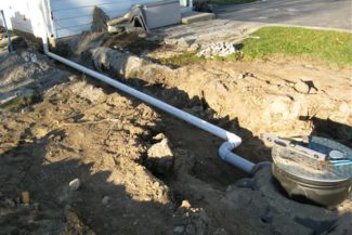 septic system half uncovered in the ground
