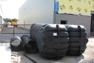 plastic septic holding tanks in front of warehouse